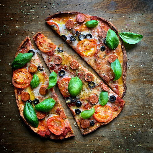 A pizza cut into slices. Photo by LikeMeat via Unsplash